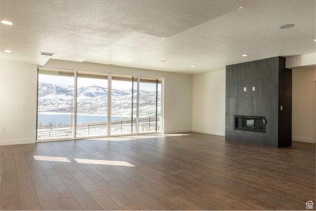 496 E Kayak Dr Unit 306, Hideout, UT 84036 - unfurnished living room with baseboards, wood finished floors, a textured ceiling, and visible vents