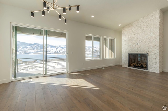 496 E Kayak Dr Unit 306, Hideout, UT 84036 - unfurnished living room with baseboards, a chandelier, a mountain view, and a fireplace