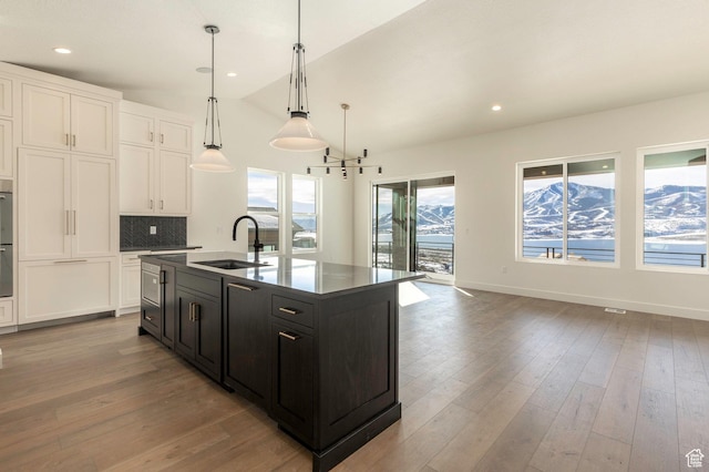 496 E Kayak Dr Unit 306, Hideout, UT 84036 - kitchen with a sink, recessed lighting, backsplash, white cabinetry, and dark cabinetry