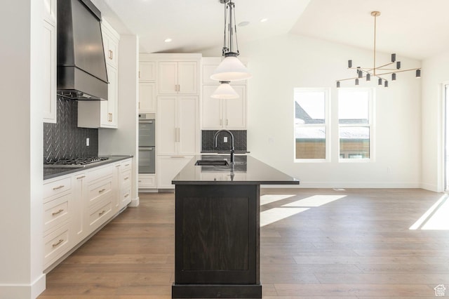 496 E Kayak Dr Unit 306, Hideout, UT 84036 - kitchen with dark countertops, tasteful backsplash, a sink, stainless steel appliances, and premium range hood