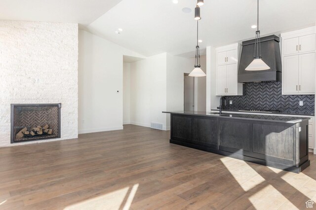 496 E Kayak Dr Unit 306, Hideout, UT 84036 - kitchen featuring visible vents, custom exhaust hood, white cabinetry, lofted ceiling, and decorative backsplash