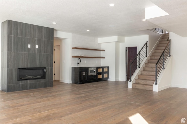 496 E Kayak Dr Unit 306, Hideout, UT 84036 - unfurnished living room with baseboards, wood finished floors, and stairs