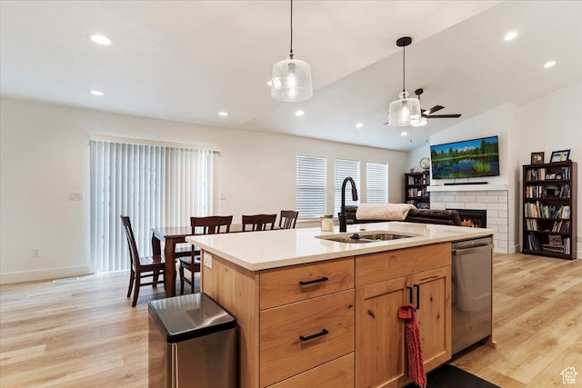 816 E Clover Way, Morgan, UT 84050 - kitchen with a ceiling fan, a sink, dishwasher, light wood finished floors, and a brick fireplace