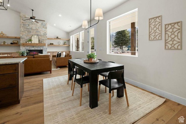48 N Meadow Dr, Pine Valley, UT 84781 - dining space featuring baseboards, a ceiling fan, a stone fireplace, and light wood-style flooring
