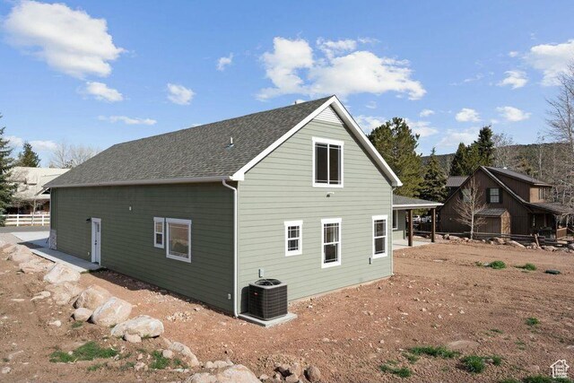 48 N Meadow Dr, Pine Valley, UT 84781 - back of house featuring central air condition unit, fence, and roof with shingles