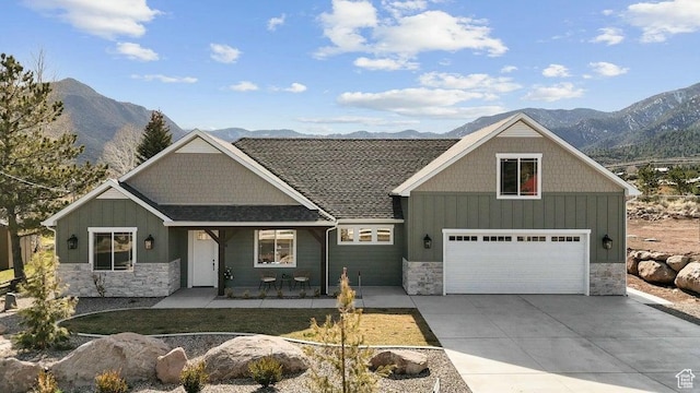 view of front of home with a mountain view, stone siding, and board and batten siding