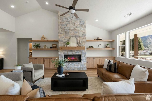 48 N Meadow Dr, Pine Valley, UT 84781 - living room with visible vents, light wood-style floors, a fireplace, high vaulted ceiling, and ceiling fan