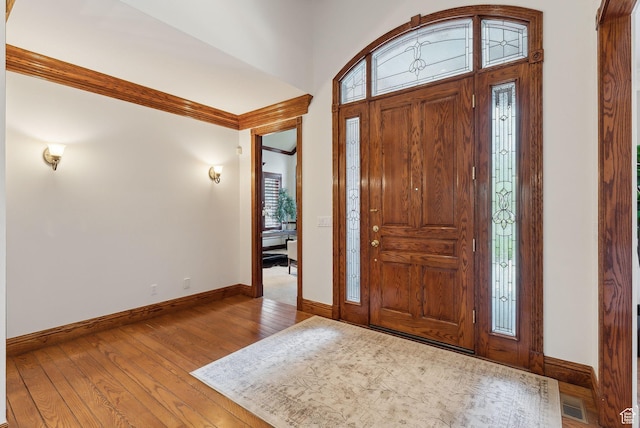 6391 S Shenandoah Park Ave E, Salt Lake City, UT 84121 - foyer with hardwood / wood-style flooring, baseboards, ornamental molding, and visible vents