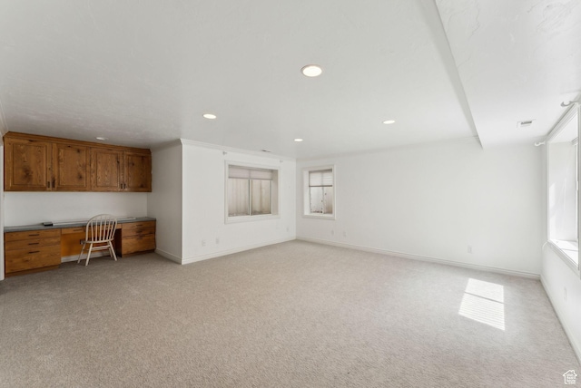 6391 S Shenandoah Park Ave E, Salt Lake City, UT 84121 - unfurnished living room featuring built in study area, baseboards, light colored carpet, and recessed lighting