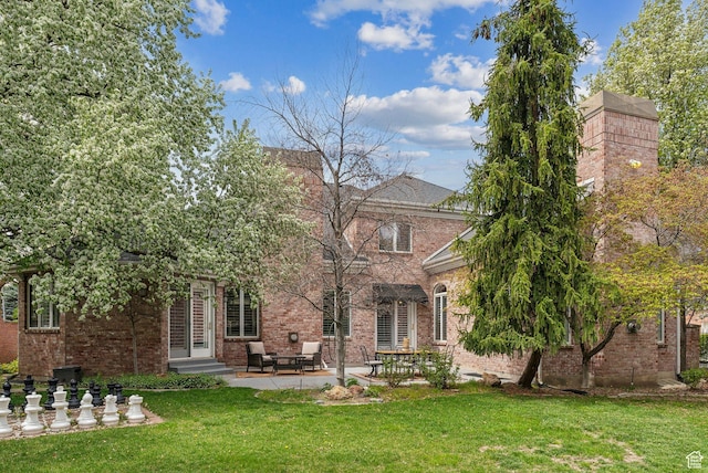 6391 S Shenandoah Park Ave E, Salt Lake City, UT 84121 - back of property featuring brick siding, a yard, and a patio