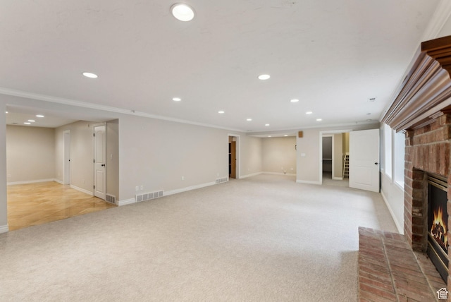 6391 S Shenandoah Park Ave E, Salt Lake City, UT 84121 - below grade area with light carpet, baseboards, a brick fireplace, visible vents, and recessed lighting