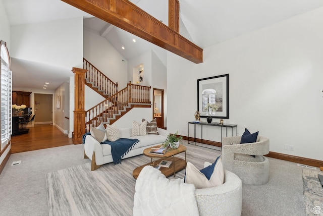 6391 S Shenandoah Park Ave E, Salt Lake City, UT 84121 - carpeted living room with beam ceiling, baseboards, high vaulted ceiling, and stairs
