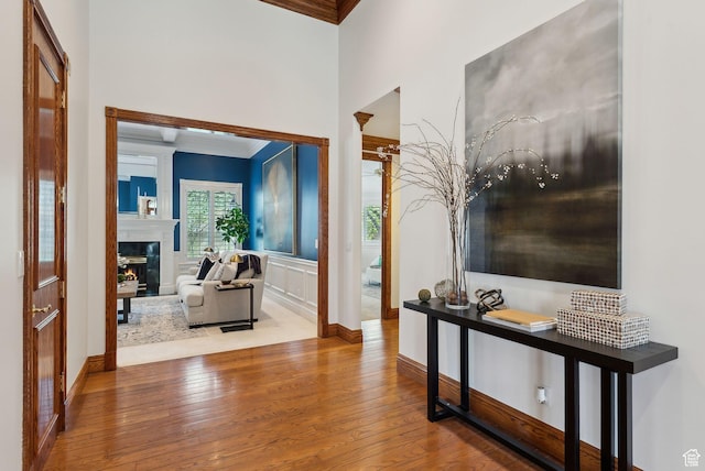 6391 S Shenandoah Park Ave E, Salt Lake City, UT 84121 - corridor featuring wood finished floors, a towering ceiling, baseboards, and ornamental molding