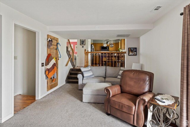 6241 S Barton Park Dr, West Jordan, UT 84081 - carpeted living room featuring baseboards, stairs, and visible vents