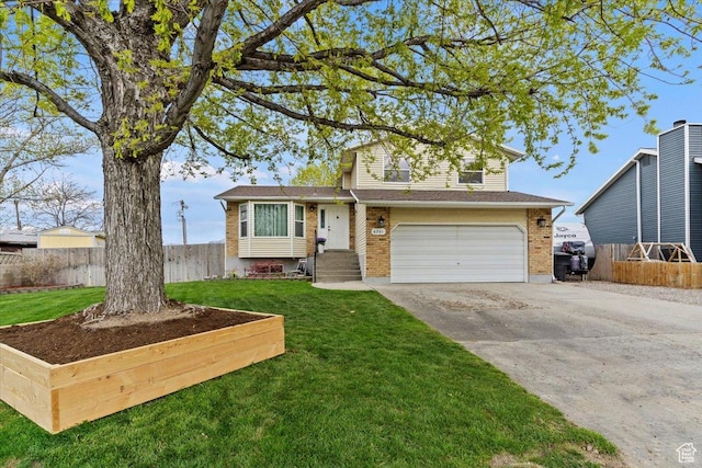 6241 S Barton Park Dr, West Jordan, UT 84081 - split level home featuring fence, a front lawn, driveway, brick siding, and a garage