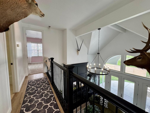 1844 W Heritage Ranch Dr N, Farr West, UT 84404 - hallway with wood finished floors, an upstairs landing, a chandelier, vaulted ceiling with beams, and baseboards