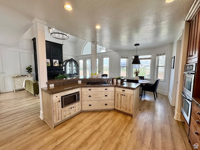 1844 W Heritage Ranch Dr N, Farr West, UT 84404 - kitchen with dark countertops, appliances with stainless steel finishes, a textured ceiling, and light brown cabinetry
