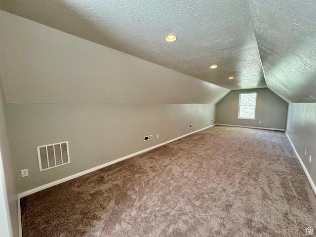 1844 W Heritage Ranch Dr N, Farr West, UT 84404 - additional living space with vaulted ceiling, a textured ceiling, carpet, baseboards, and visible vents