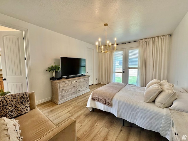 1844 W Heritage Ranch Dr N, Farr West, UT 84404 - bedroom with a notable chandelier, light wood finished floors, french doors, baseboards, and access to outside