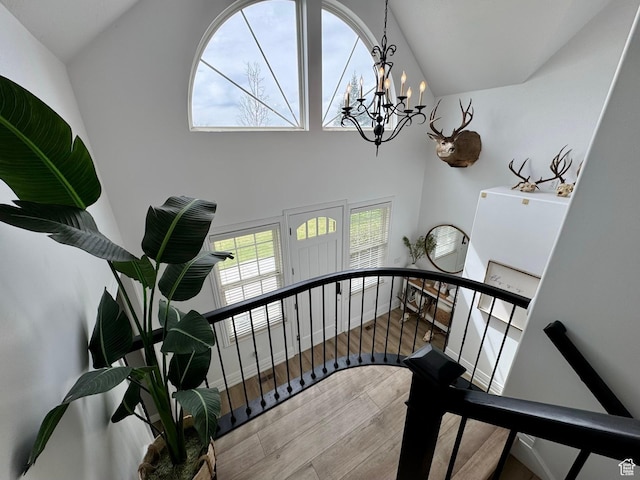 1844 W Heritage Ranch Dr N, Farr West, UT 84404 - stairs featuring wood finished floors, baseboards, and a notable chandelier