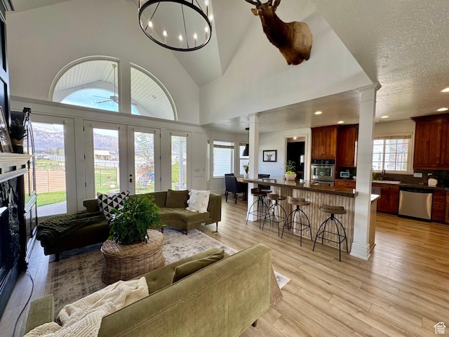 1844 W Heritage Ranch Dr N, Farr West, UT 84404 - living room with recessed lighting, ornate columns, a ceiling fan, light wood-style floors, and high vaulted ceiling