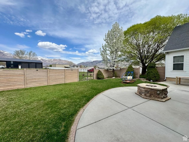 1844 W Heritage Ranch Dr N, Farr West, UT 84404 - view of yard featuring a fire pit, fence private yard, a mountain view, and a patio