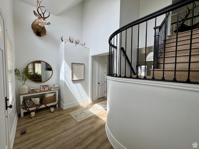 1844 W Heritage Ranch Dr N, Farr West, UT 84404 - foyer entrance featuring stairway, wood finished floors, a towering ceiling, baseboards, and visible vents