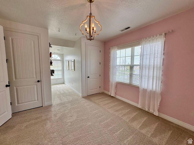 1844 W Heritage Ranch Dr N, Farr West, UT 84404 - empty room with light carpet, a notable chandelier, a textured ceiling, and visible vents