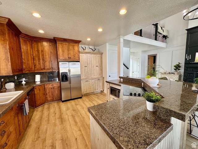 1844 W Heritage Ranch Dr N, Farr West, UT 84404 - kitchen featuring light wood-type flooring, appliances with stainless steel finishes, brown cabinetry, and a sink