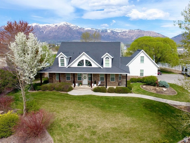 1844 W Heritage Ranch Dr N, Farr West, UT 84404 - cape cod home with a porch, a front yard, and a mountain view