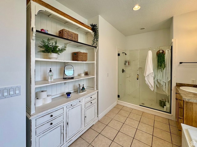 1844 W Heritage Ranch Dr N, Farr West, UT 84404 - full bathroom with tile patterned floors, vanity, baseboards, a textured ceiling, and a stall shower