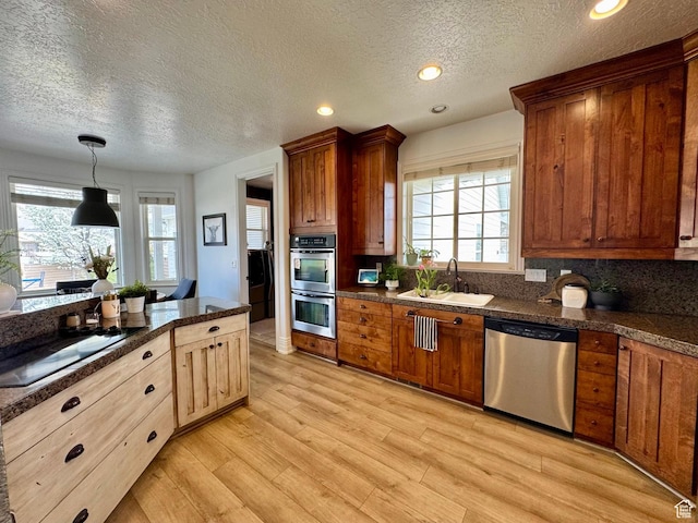 1844 W Heritage Ranch Dr N, Farr West, UT 84404 - kitchen with dark countertops, a textured ceiling, appliances with stainless steel finishes, and a sink