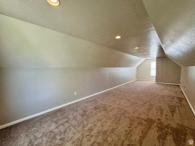 1844 W Heritage Ranch Dr N, Farr West, UT 84404 - bonus room with baseboards, a textured ceiling, and carpet