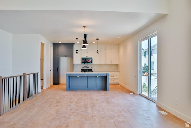 61 N 2430 W Unit 6, Lehi, UT 84043 - kitchen with stainless steel microwave, plenty of natural light, baseboards, light countertops, and recessed lighting