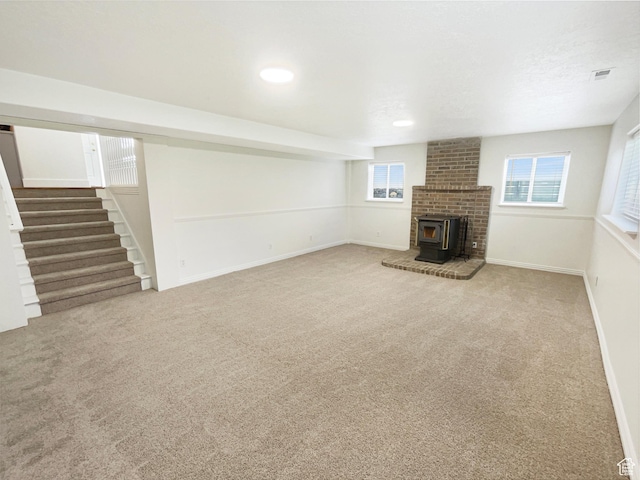 112 E Ama Fille Ln, Payson, UT 84651 - unfurnished living room featuring baseboards, carpet, stairs, and a wood stove