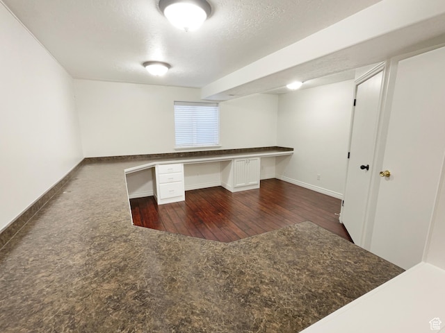 112 E Ama Fille Ln, Payson, UT 84651 - unfurnished office featuring built in study area, baseboards, dark wood-type flooring, and a textured ceiling