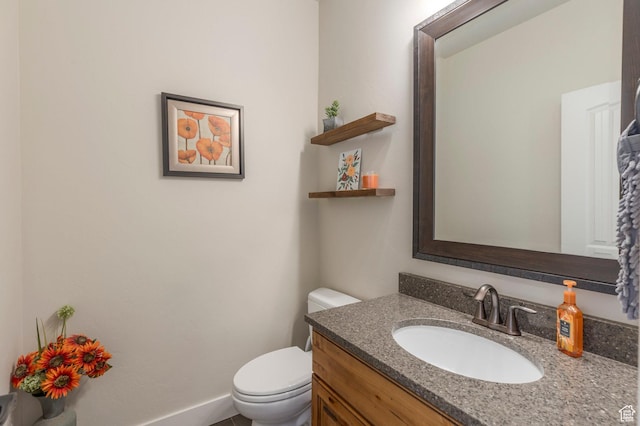 half bathroom featuring toilet and vanity