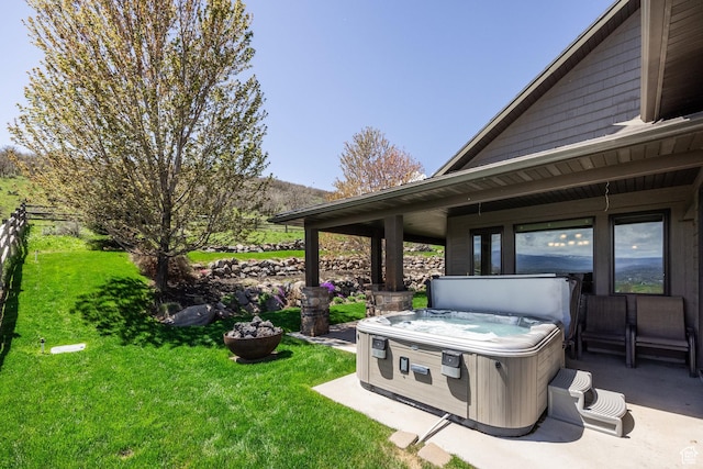 view of grassy yard with a hot tub