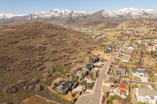 aerial view of property and surrounding area with nearby suburban area and mountains