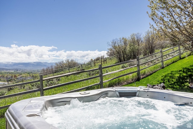 wooden deck featuring fence and a hot tub