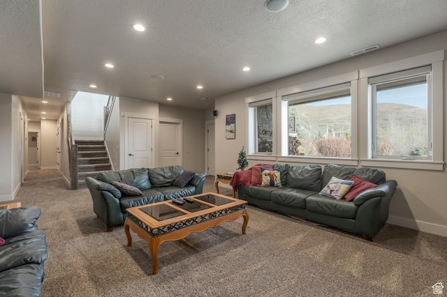 living room with carpet, recessed lighting, baseboards, stairway, and a textured ceiling