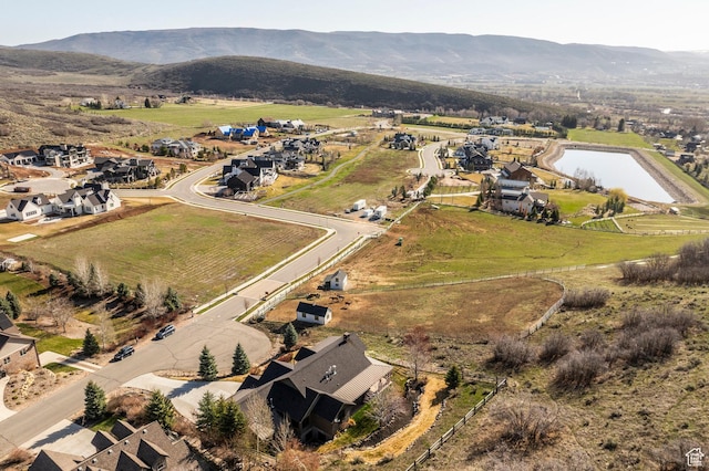 view of property location with a water and mountain view and rural landscape