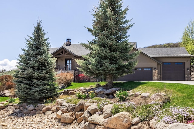 view of property hidden behind natural elements featuring a garage, a chimney, and stone siding