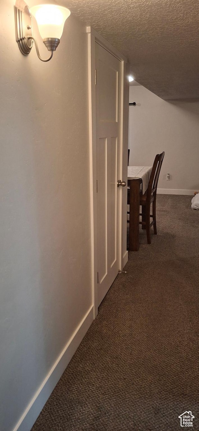 4502 S Stonington Way, Taylorsville, UT 84129 - hallway featuring dark carpet, baseboards, and a textured ceiling
