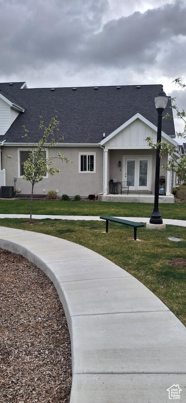 4502 S Stonington Way, Taylorsville, UT 84129 - view of front facade featuring a shingled roof, a front lawn, and central AC