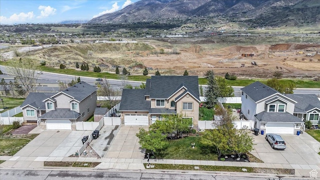 birds eye view of property with a mountain view and a residential view