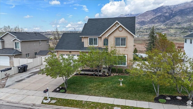 view of front of home with a front lawn, driveway, stone siding, a garage, and stucco siding