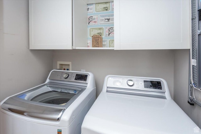 laundry area featuring washer and dryer and cabinet space