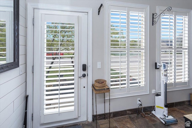 doorway to outside with a healthy amount of sunlight and baseboards