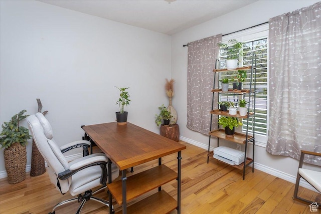 office featuring baseboards and light wood-style flooring